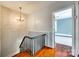 Upstairs hallway with decorative light fixture, wood accent wall and hardwood floors at 309 N Congress N St, York, SC 29745