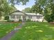 Charming white brick home featuring a beautiful lawn and manicured landscaping at 3615 Champaign St, Charlotte, NC 28210
