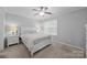 Bright bedroom with a ceiling fan, large window, and comfortable carpet flooring at 3736 Melrose Cottage Dr, Matthews, NC 28105