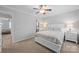 Spacious bedroom with an ensuite bathroom and large bed, featuring ceiling fan and ample light at 3736 Melrose Cottage Dr, Matthews, NC 28105