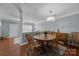 Cozy dining area featuring hardwood floors, classic wooden furniture and a modern light fixture at 3736 Melrose Cottage Dr, Matthews, NC 28105