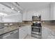 Well-equipped kitchen featuring stainless steel appliances, white cabinets, and granite countertops at 3736 Melrose Cottage Dr, Matthews, NC 28105