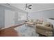 Bright living room with plush seating, ceiling fan, and a large window at 3736 Melrose Cottage Dr, Matthews, NC 28105