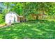 Backyard featuring a storage shed, treehouse, and green lawn in a serene setting at 3810 Springway Dr, Gastonia, NC 28056