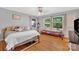 Comfortable bedroom featuring hardwood floors, natural light from three windows, and a unique window seat at 3810 Springway Dr, Gastonia, NC 28056