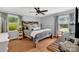 Charming bedroom with wood floors, rustic headboard, and a ceiling fan at 3810 Springway Dr, Gastonia, NC 28056
