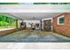 Covered carport with brick accents, offering ample storage space, and convenient access to the home's side entrance at 3810 Springway Dr, Gastonia, NC 28056
