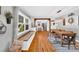 Bright dining room with large windows, a long wooden table and an open layout to the kitchen at 3810 Springway Dr, Gastonia, NC 28056