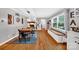 Well-lit dining room with a farmhouse table, built-in bench seating, and hardwood floors at 3810 Springway Dr, Gastonia, NC 28056