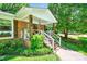 Inviting front porch with brick steps, white railings, and decorative touches add to the home's curb appeal at 3810 Springway Dr, Gastonia, NC 28056