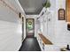 Hallway featuring black tiled floors, wood accents, and a mudroom rack with bench at 3810 Springway Dr, Gastonia, NC 28056
