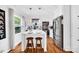 Bright kitchen features white cabinets, stainless steel appliances, an island, and hardwood floors at 3810 Springway Dr, Gastonia, NC 28056
