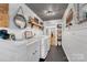 Bright laundry room with sink, washer, dryer, and shelving for ample storage at 3810 Springway Dr, Gastonia, NC 28056