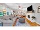 Inviting living room features a painted brick fireplace, a hardwood floor, and lots of natural light at 3810 Springway Dr, Gastonia, NC 28056