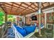 Inviting covered patio with a TV, comfortable seating, string lights, and outdoor decor at 3810 Springway Dr, Gastonia, NC 28056