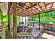 Cozy covered outdoor patio featuring a ceiling fan, seating, grill, and a relaxing swing at 3810 Springway Dr, Gastonia, NC 28056