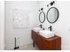 Modern bathroom features double sinks, wooden vanity, and contemporary fixtures at 4211 Mantle Ct, Charlotte, NC 28205