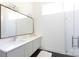 Bright bathroom features double sinks, minimalist design, and a sleek, frameless shower at 4211 Mantle Ct, Charlotte, NC 28205