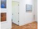 Hallway with hardwood floors and modern artwork leading to other rooms in the home at 4211 Mantle Ct, Charlotte, NC 28205