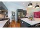 Modern kitchen featuring stainless steel appliances, a pantry, white countertops and warm hardwood floors at 4211 Mantle Ct, Charlotte, NC 28205