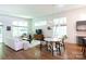 Open-concept living room and dining area with hardwood floors and large windows for natural light at 4211 Mantle Ct, Charlotte, NC 28205