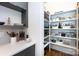 Well-organized pantry with white shelving and hardwood floors located just off the kitchen at 4211 Mantle Ct, Charlotte, NC 28205
