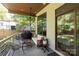 Relax on this covered patio with comfortable seating, ceiling fan, and space for a grill at 4211 Mantle Ct, Charlotte, NC 28205