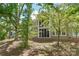 Private backyard with screened porch offering a peaceful retreat surrounded by mature trees and landscaping at 44449 Oriole Dr # 101, Indian Land, SC 29707