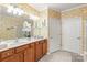 Bathroom featuring double sink vanity, decorative wallpaper, and lots of natural light at 44449 Oriole Dr # 101, Indian Land, SC 29707
