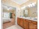 Primary bathroom featuring a double sink vanity that connects to the bedroom and has decorative wallpaper at 44449 Oriole Dr # 101, Indian Land, SC 29707