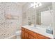 Well-lit bathroom with a vanity and patterned wallpaper, providing a functional and stylish space at 44449 Oriole Dr # 101, Indian Land, SC 29707
