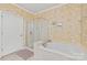Bathroom with a large soaking tub, glass enclosed shower, and decorative wallpaper at 44449 Oriole Dr # 101, Indian Land, SC 29707