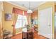 Bright breakfast nook area with a cozy table and chairs by a window and hardwood floors at 44449 Oriole Dr # 101, Indian Land, SC 29707