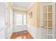 Welcoming foyer with hardwood floors, wainscoting, and a bright front door, offering a charming entrance at 44449 Oriole Dr # 101, Indian Land, SC 29707