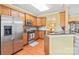 Modern kitchen with stainless steel appliances, wooden cabinetry, and granite countertops at 44449 Oriole Dr # 101, Indian Land, SC 29707