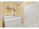 Functional laundry room equipped with modern appliances and shelving, simplifying household tasks at 44449 Oriole Dr # 101, Indian Land, SC 29707