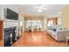 Spacious living room with a cozy fireplace, large windows, and hardwood floors at 44449 Oriole Dr # 101, Indian Land, SC 29707