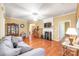 Comfortable living room featuring hardwood floors, a fireplace, and a seamless flow to other rooms at 44449 Oriole Dr # 101, Indian Land, SC 29707