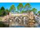 Sun City Carolina Lakes entrance featuring a beautiful stone waterfall at 44449 Oriole Dr # 101, Indian Land, SC 29707