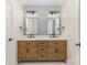 Well-lit bathroom featuring double vanity, stylish mirrors, and modern fixtures at 4907 Ardenwoods Dr, Charlotte, NC 28215