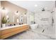 Elegant bathroom highlighting a double vanity, arched mirrors, modern lighting and a freestanding tub with marble accents at 4907 Ardenwoods Dr, Charlotte, NC 28215