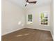 Empty bedroom with hardwood floors, ceiling fan, and two bright windows at 4907 Ardenwoods Dr, Charlotte, NC 28215