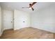 Bright bedroom featuring hardwood floors, modern accent wall and closet doors at 4907 Ardenwoods Dr, Charlotte, NC 28215