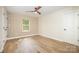 Inviting bedroom space with decorative trim and hardwood floors with window view at 4907 Ardenwoods Dr, Charlotte, NC 28215