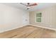 Inviting bedroom space with decorative trim and hardwood floors with window view at 4907 Ardenwoods Dr, Charlotte, NC 28215