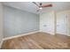 Light-filled bedroom with hardwood floors and a stylish accent wall at 4907 Ardenwoods Dr, Charlotte, NC 28215