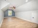 Bright bonus room with wood floors and a modern ceiling fan at 4907 Ardenwoods Dr, Charlotte, NC 28215