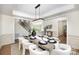 Formal dining room with a modern chandelier, seating for eight, and hardwood floors at 4907 Ardenwoods Dr, Charlotte, NC 28215