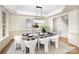 Elegant dining room with stylish light fixture, hardwood floors, and seating for eight at 4907 Ardenwoods Dr, Charlotte, NC 28215
