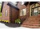 Close up of brick entrance with stylish front door, detailed trim, and wrought iron railings at 4907 Ardenwoods Dr, Charlotte, NC 28215